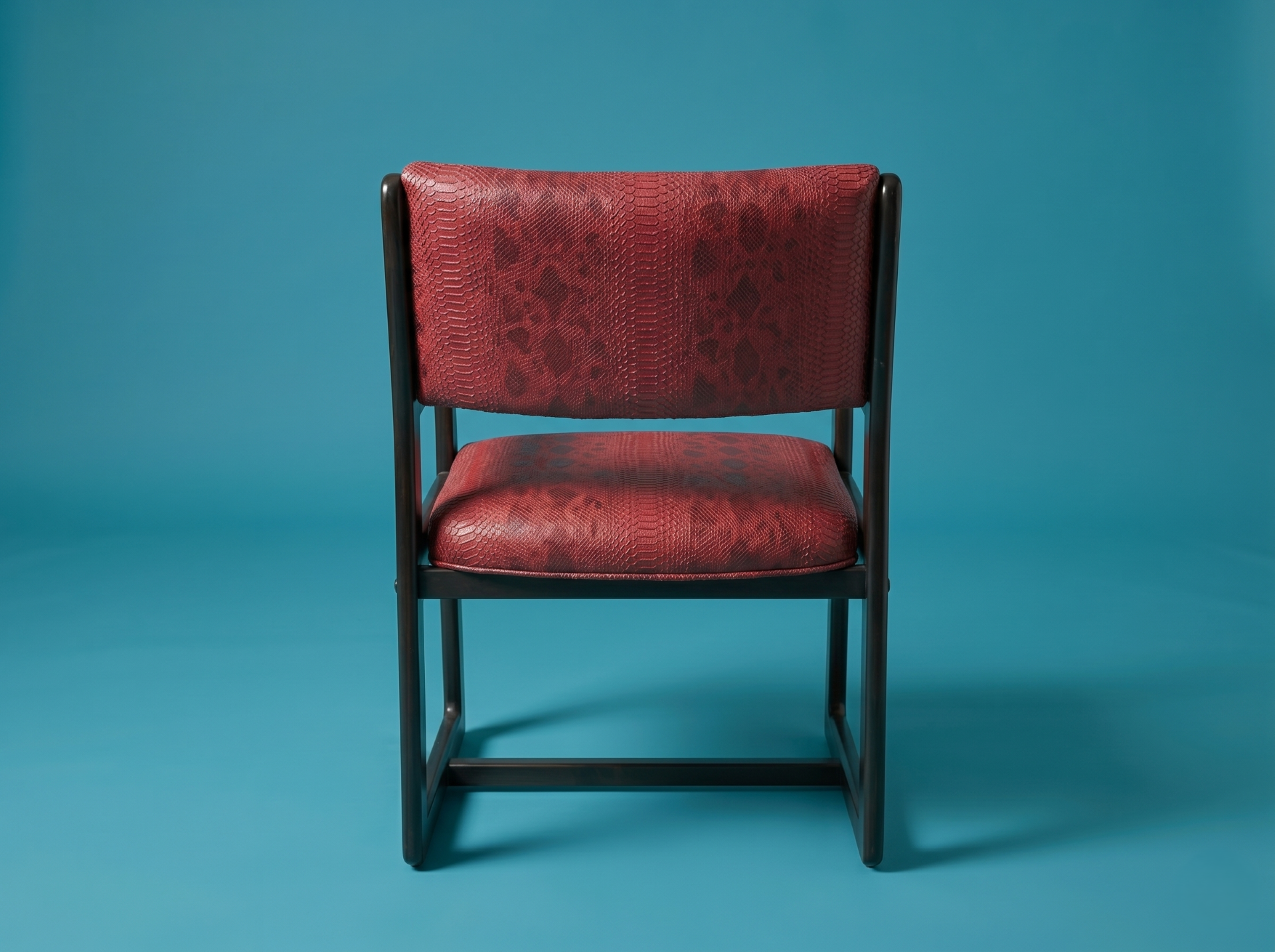 MCM RED REPTILE PRINT CHAIR **